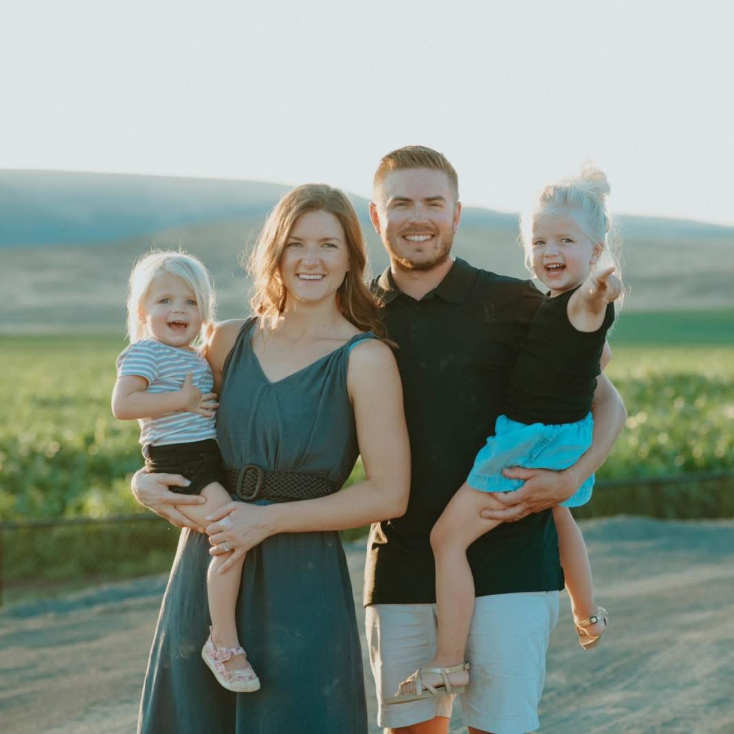 Kendahl with her husband and their two daughters outdoors